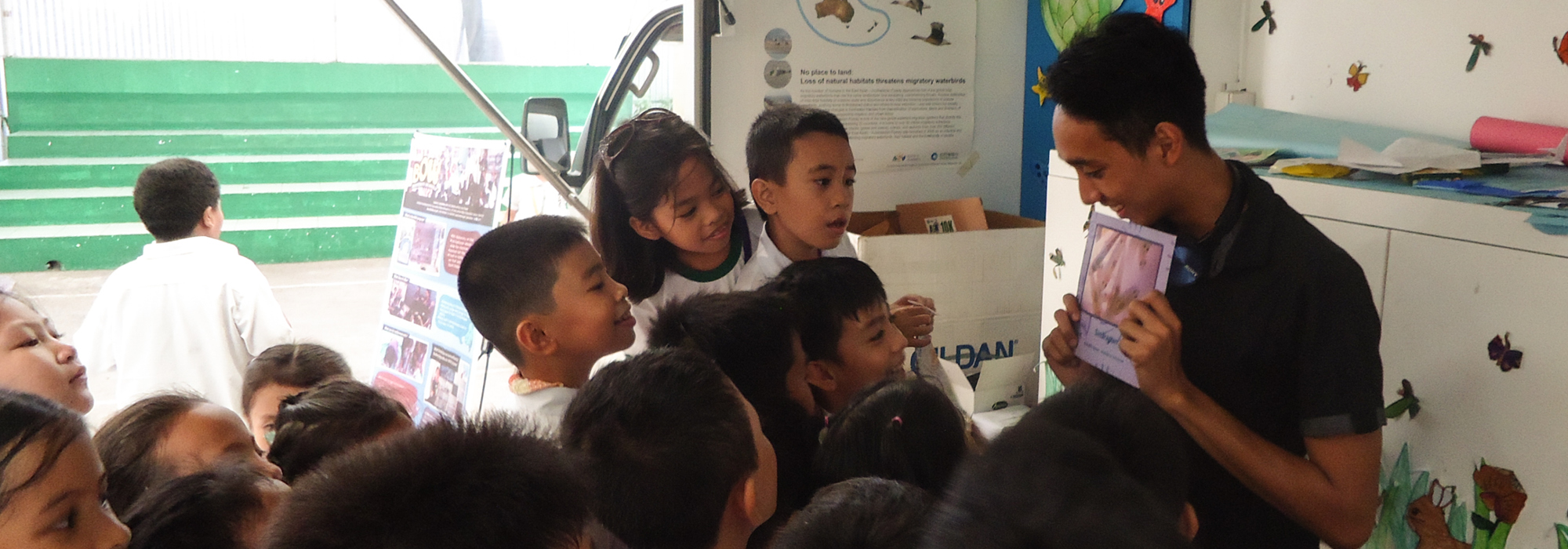 07312016 Children browse picture books inside the Biodiversity on Wheels library photo by Esther R. Romarate